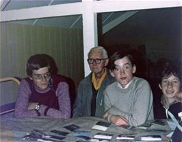 Phil, Frank, John and Mark examine Michael's recently-returned batch of photos from the Summer tour at Salcombe youth hostel