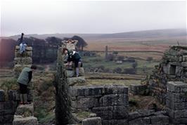 Nigel, John, Kevin and Mark on one of the waterwheel housings, with a chimney and other buildings in the distance