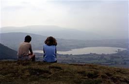 John and Jackie take in the view to Llangors Lake from Mynydd Llangorse, after walking up Cockit Hill from the road