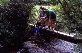 Mark, Antony and Colin exact revenge on Matthew in the water pump war, on the footbridge at North Bovey ford