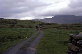 A mile from the hostel and our road goes through a gateway and starts to look more like a track.  Rhinog Fawr ("Big Rhinog") in the clouds