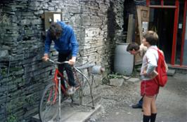 Stephen Downer converts pedal power to electrical power at the Alternative Energy Centre while John and Simon keep a close eye on his output levels