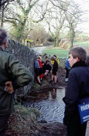 Colin looks on and the group uses Gidley Bridge to keep off the chilly wind while Duncan repairs his puncture