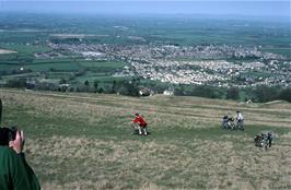 Steep climbing on the Winchcombe Way path from Cleeve Hill, with Woodmancote and Bishops Cleeve beyond