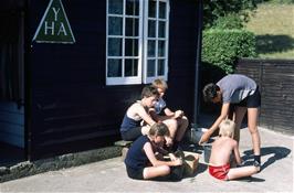 Our youngsters giving maximum concentration to their unusual hostel chore at Gidleigh youth hostel - shelling a box of peas!