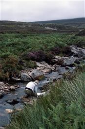 Andy Billington washing his clothes in the stream beside Achininver youth hostel