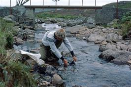 Andy Billington washing his clothes in the stream