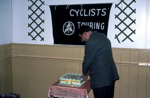 Les Sparkes, president of the Devon DA, cuts the anniversary cake at Kenton Village Hall