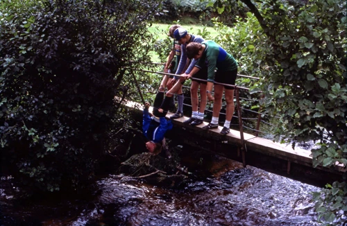 Mark, Antony and Colin exact revenge on Matthew in the water pump war, on the footbridge at North Bovey ford