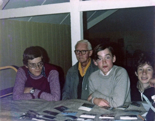 Philip, Frank, John and Mark examine Michael's recently returned photos from the summer tour at Salcombe youth hostel